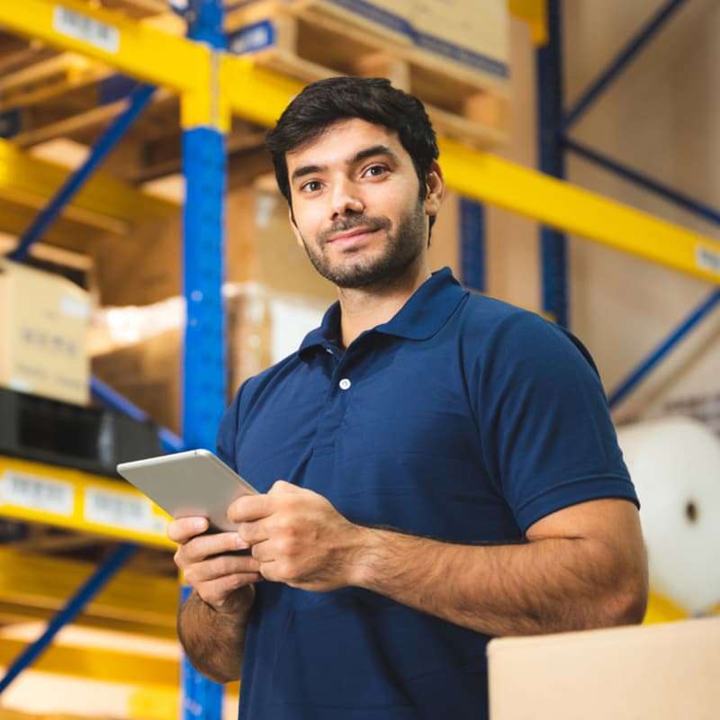 man holding tablet in a warehouse