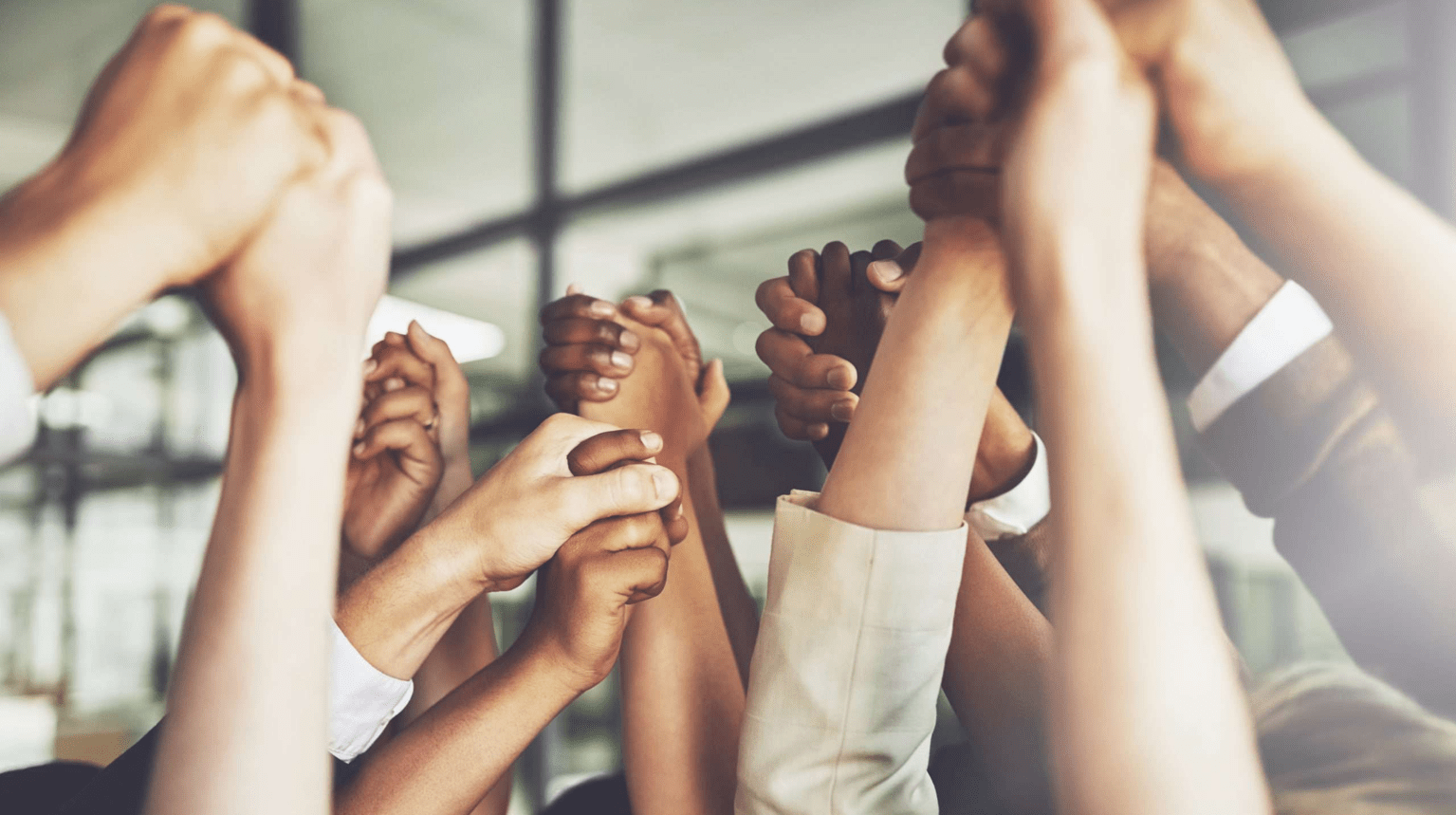 People holding hands to symbolize social community.